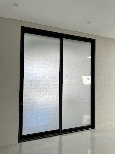 Decorative frosted film providing privacy to a bathroom window